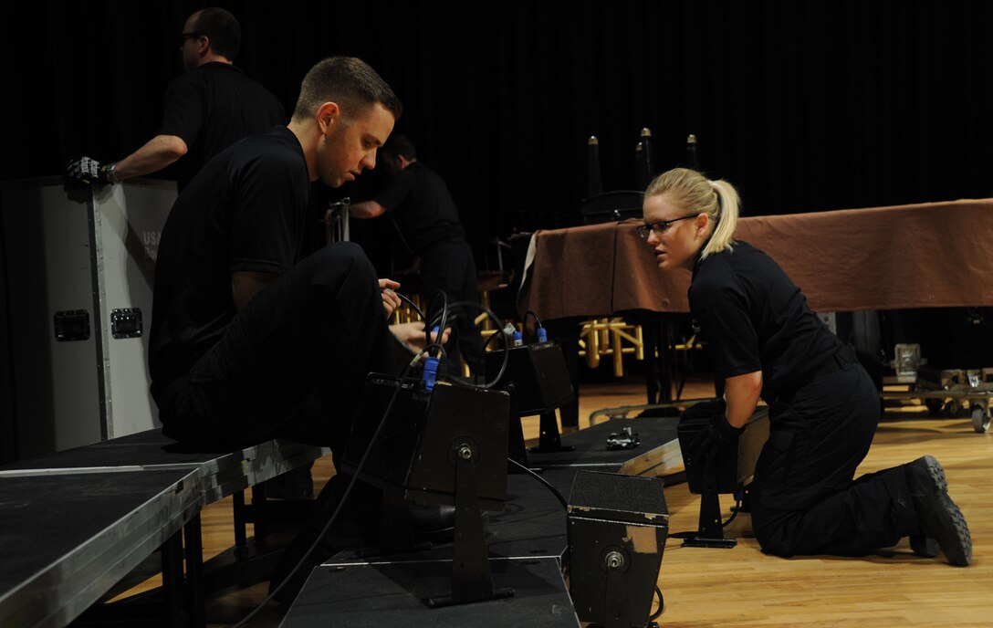 Tech. Sgts. Daniel Anderson and Hannah Rigg set-up a speaker system prior to a performance by The U.S. Air Force Band at Davison High School in Davison, Mich., April 12, 2014. Anderson is a tenor vocalist with the Singing Sergeants, the official chorus of the U.S. Air Force. Rigg, a native of Tomball, Texas, is a soprano vocalist with the Singing Sergeants. (U.S. Air Force photo/Master Sgt. Tammie Moore)