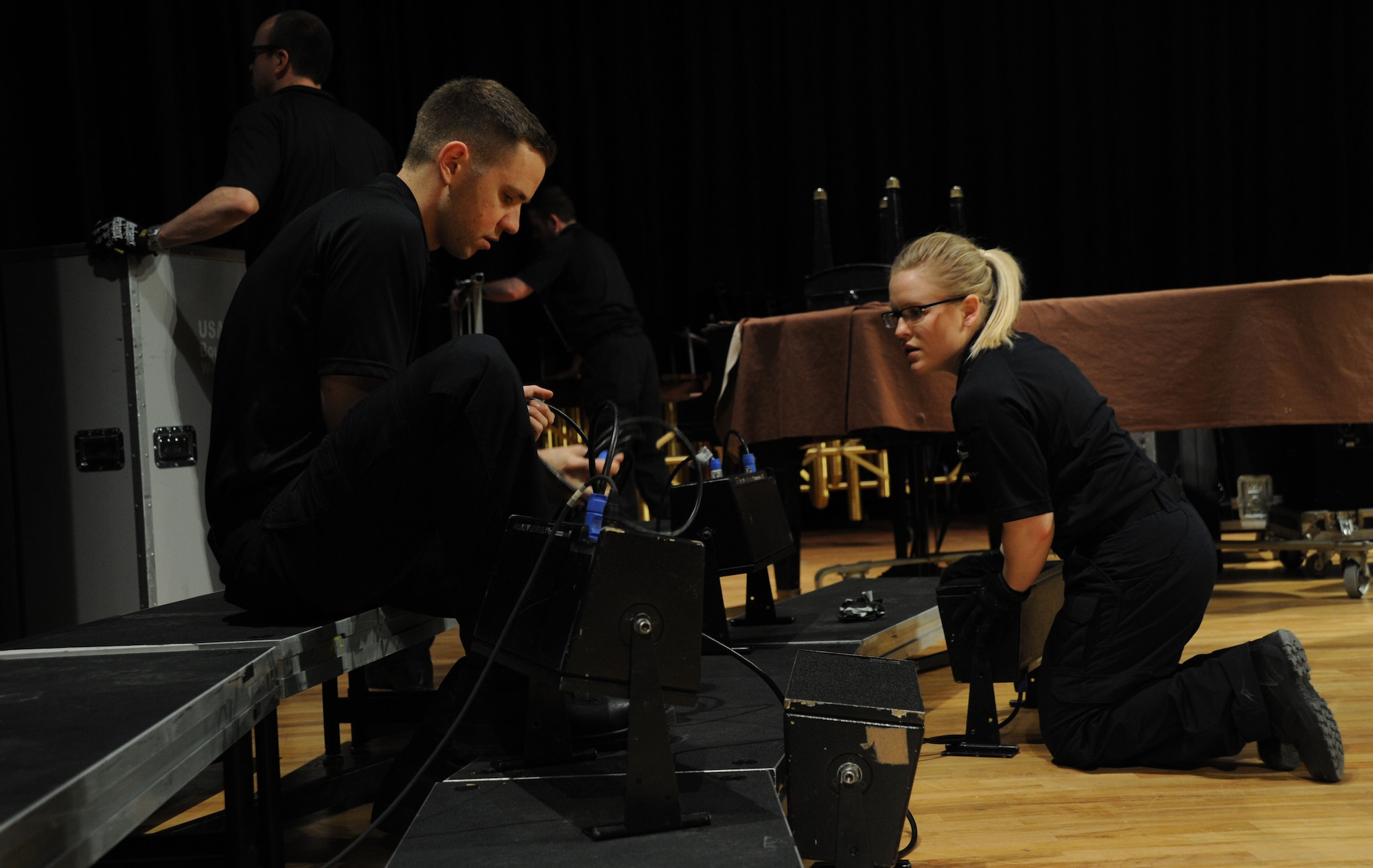 Tech. Sgts. Daniel Anderson and Hannah Rigg set-up a speaker system prior to a performance by The U.S. Air Force Band at Davison High School in Davison, Mich., April 12, 2014. Anderson is a tenor vocalist with the Singing Sergeants, the official chorus of the U.S. Air Force. Rigg, a native of Tomball, Texas, is a soprano vocalist with the Singing Sergeants. (U.S. Air Force photo/Master Sgt. Tammie Moore)