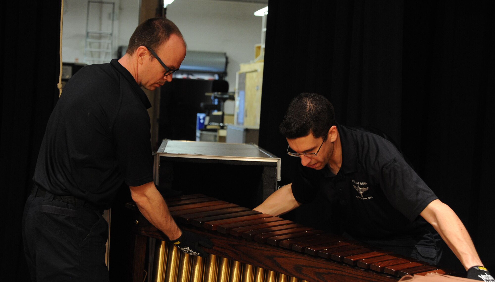 Tech. Sgts. Micah Killion (left) and Dave Balandrin unpack a xylophone prior to a performance by The U.S. Air Force Band at Davison High School in Davison, Mich., April 12, 2014. Killion, a native of Gainesville, Fla., is a trumpeter with the Concert Band. Balandrin, a native of Salt Lake City, is a French hornist with the Concert Band. (U.S. Air Force photo/Master Sgt. Tammie Moore)