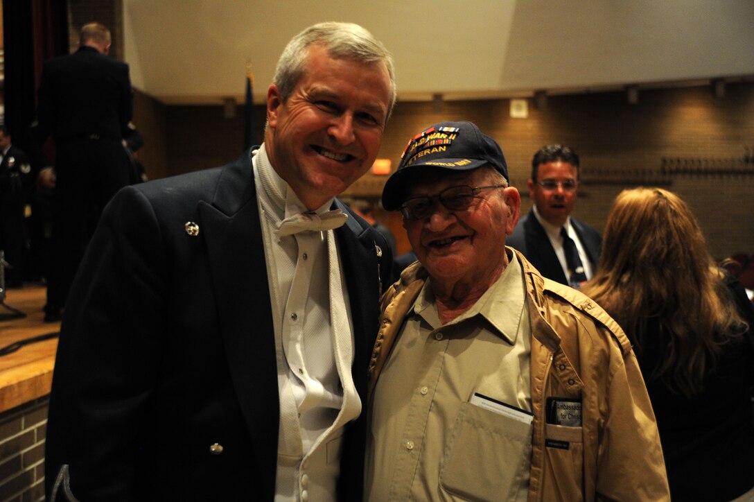 Col. Larry Lang poses for a photo with a retired Air Force sergeant and World War II veteran  Jack Brown after a performance by The U.S. Air Force Band at Davison High School in Davison, Mich., April 12, 2014. Lang, a native of El Paso, Texas, is the Band commander and conductor. (U.S. Air Force photo/Master Sgt. Tammie Moore)