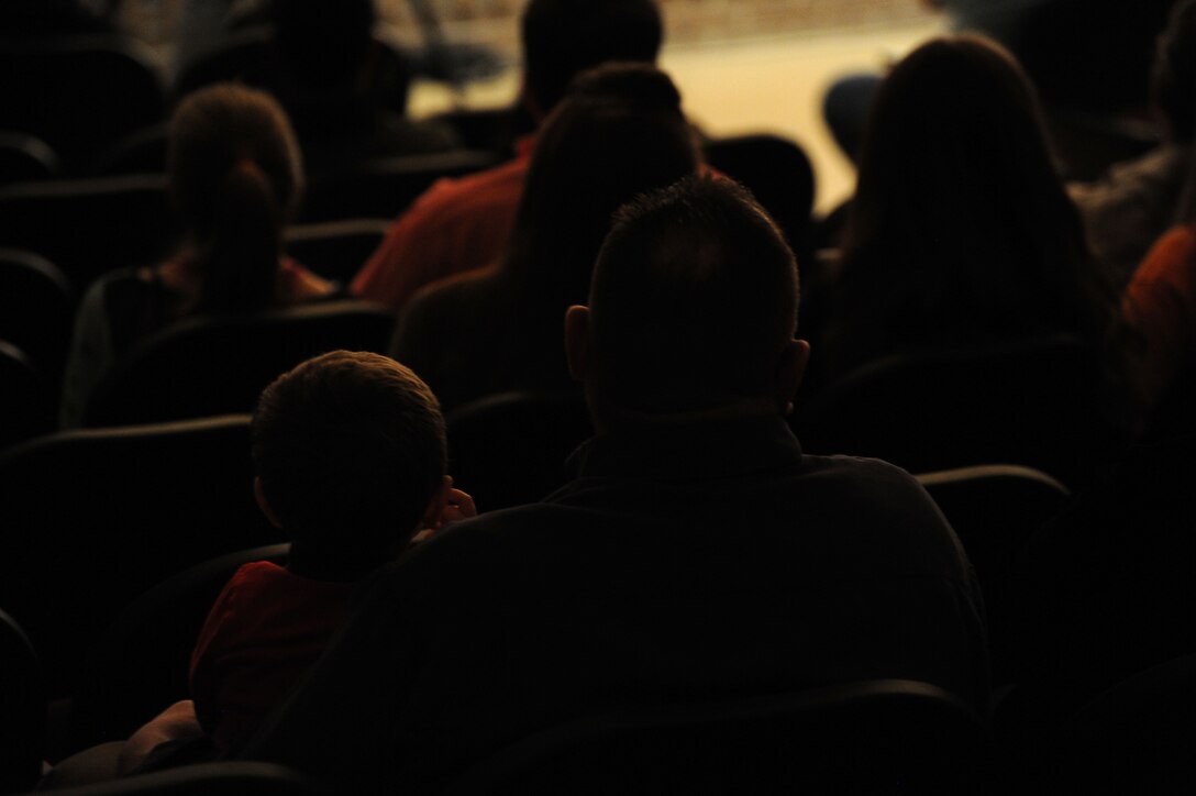 A father and child enjoy a performance by The U.S. Air Force Band Davison High School in Davison, Mich., April 12, 2014. This show is part of the Band’s spring tour featuring the Concert Band, the Band’s largest ensemble, and the Singing Sergeants, the official chorus of the U.S. Air Force. (U.S. Air Force photo/Master Sgt. Tammie Moore)