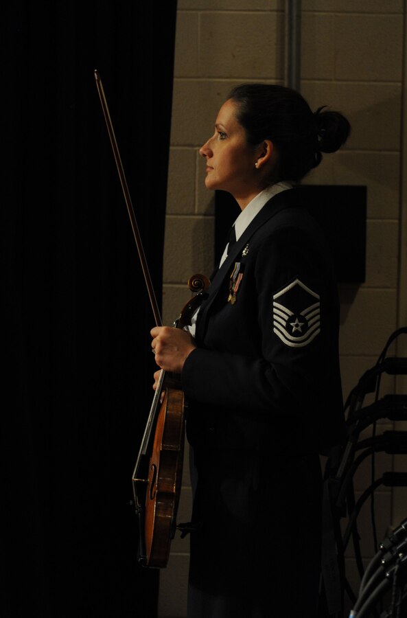 Master Sgt. Emily Wellington waits for her cue prior to her violin solo during The U.S. Air Force Band’s 2014 Spring Concert Tour show at Davison High School in Davison, Mich., April 12, 2014. Wellington, a native of Lemoyne, Pa., is an alto vocalist with the Singing Sergeants, the official chorus of the U.S. Air Force Band. Wellington graduated from Temple University with a Bachelor of Music in music education with a violin concentration. (U.S. Air Force photo/Master Sgt. Tammie Moore)