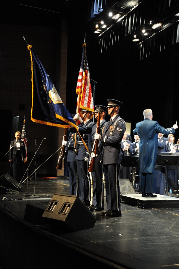 U.S. Air Force Honor Guard Airmen present the colors before a performance by The U.S. Air Force Band at Eisenhower High School in Shelby Township, Mich., April 10, 2014. The men and women of the Air Force Honor Guard represent every member, both past and present, of the Air Force. Airmen of every enlisted rank, including company and field grade officers, volunteer to join the Honor Guard and are competitively selected to serve in the elite group, making it the standard for discipline and military professionalism.  (U.S. Air Force photo/Master Sgt. Tammie Moore)