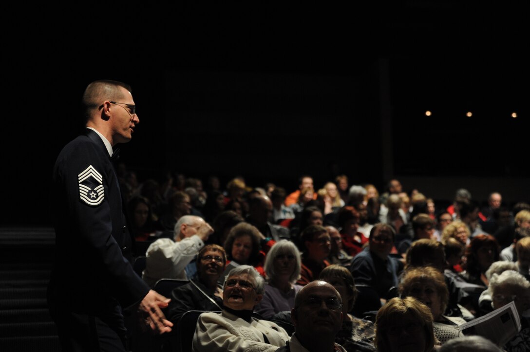 Chief Master Sgt. Mike Piersol speaks with members of the audiences before a performance by The U.S. Air Force Band at Eisenhower High School in Shelby Township, Mich., April 10, 2014. Piersol, a native of Williamsburg, Iowa, is the flight chief and principal trombonist with the Concert Band. His career in the Air Force began in 1997 with the Band of the Golden West at Travis Air Force Base, Calif. (U.S. Air Force photo/Master Sgt. Tammie Moore)