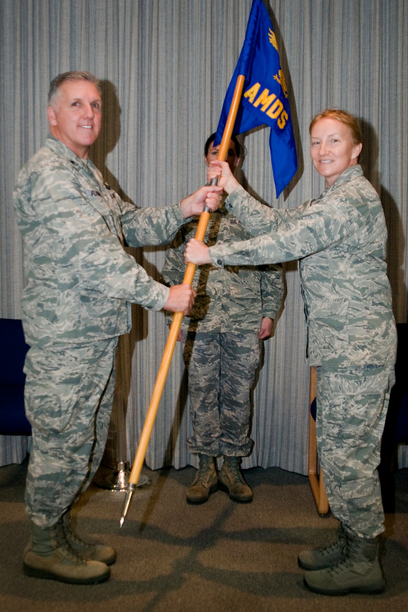 Brig. Gen. John. C. Flournoy Jr., 4th Air Force commander, presents the 434th Aerospace Medicine Squadron guidon to Lt. Col. Therese Kern as she took command of the medical unit at Grissom Air Reserve Base, Ind., April 13, 2014. Kern previously served as the 434th AMDS chief nurse. (U.S. Air Force photo/Staff Sgt. Andrew McLaughlin) 
