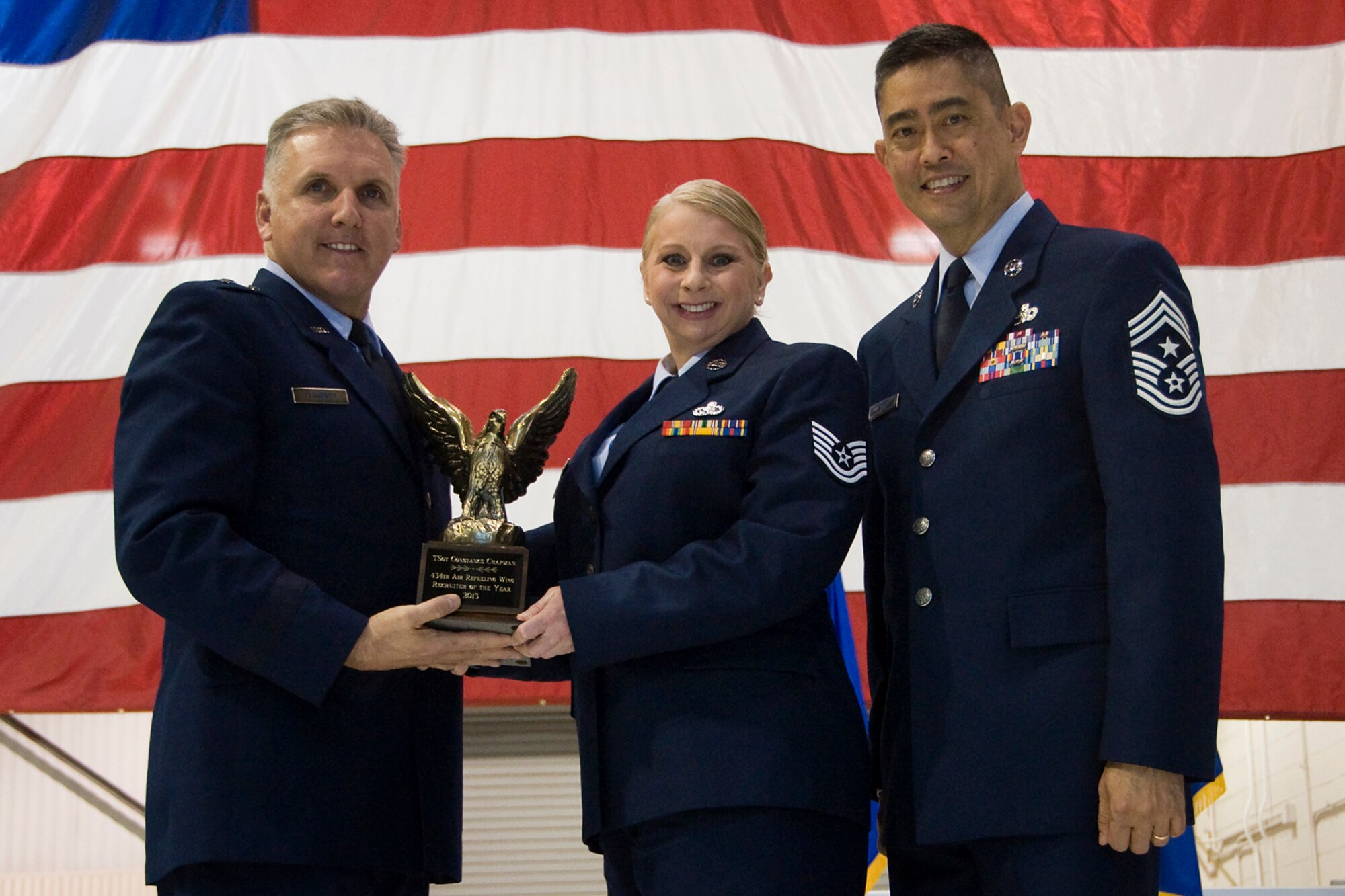 Brig. Gen. John C. Flournoy Jr., 4th Air Force commander, left, and Chief Master Sgt. Brian Wong, 4th AF command chief, right, present Tech. Sgt. Constance Chapman, Air Force Reserve recruiter in Oak Lawn, Ill., with a 434th Air Refueling Wing Recruiter of the Year for 2013 award at an annual awards banquet held at Grissom Air Reserve Base, Ind., April 12, 2014. Each year, time is set aside to honor Grissom Airmen who embody the Air Force's core values to the fullest extent through their actions and commitment to duty. (U.S. Air Force photo/Staff Sgt. Andrew McLaughlin)
