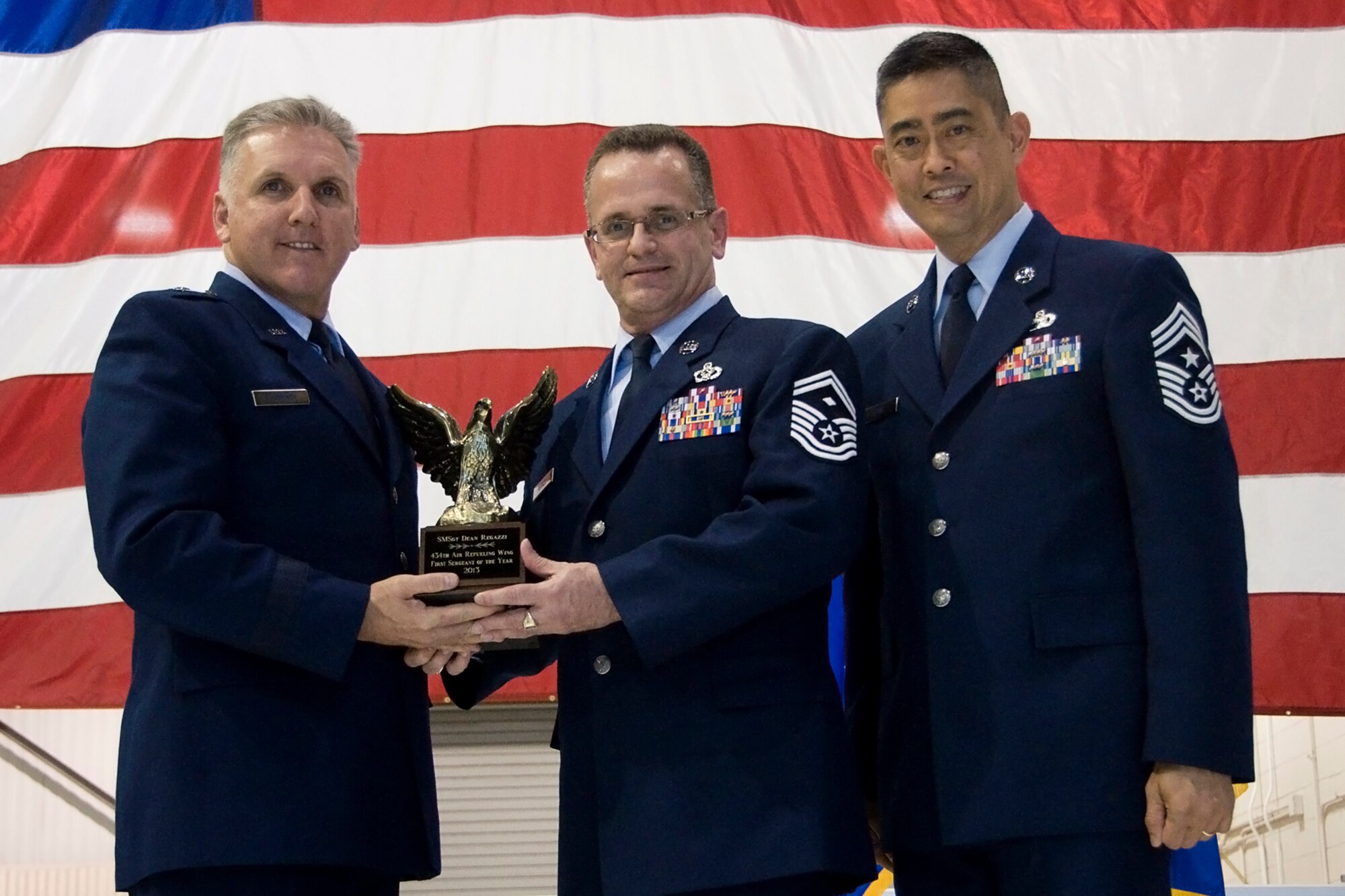 Brig. Gen. John C. Flournoy Jr., 4th Air Force commander, left, and Chief Master Sgt. Brian Wong, 4th AF command chief, right, present Senior Master Sgt. Dean Regazzi, 434th CES first sergeant, with a 434th Air Refueling Wing First Sergeant of the Year for 2013 award at an annual awards banquet held at Grissom Air Reserve Base, Ind., April 12, 2014. Each year, time is set aside to honor Grissom Airmen who embody the Air Force's core values to the fullest extent through their actions and commitment to duty. (U.S. Air Force photo/Staff Sgt. Andrew McLaughlin)
