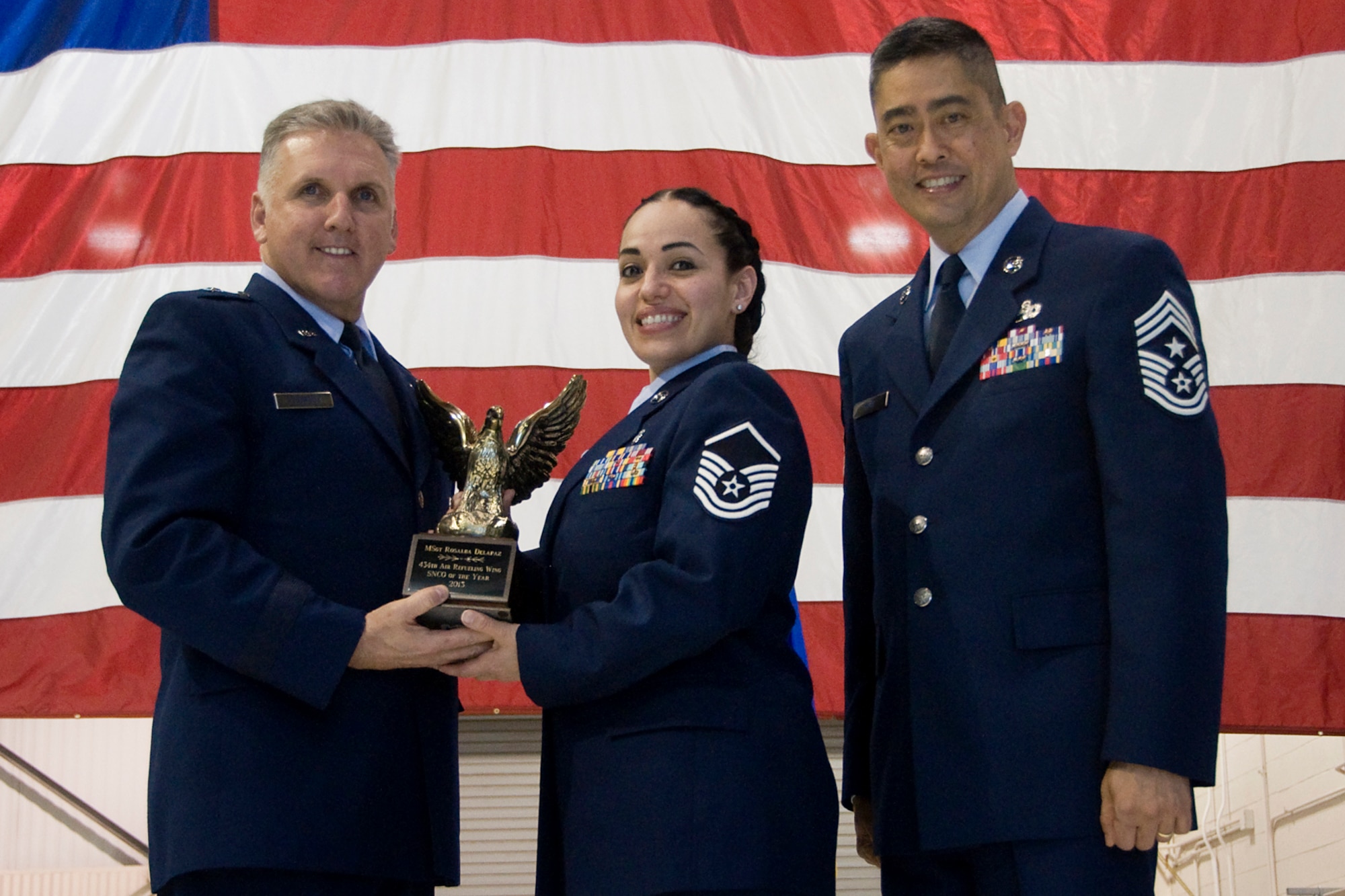 Brig. Gen. John C. Flournoy Jr., 4th Air Force commander, left, and Chief Master Sgt. Brian Wong, 4th AF command chief, right, present Master Sgt. Rosalba Delapaz, 74th Air Refueling Squadron medical technician, with a 434th Air Refueling Wing Senior Noncommissioned Officer of the Year for 2013 award at an annual awards banquet held at Grissom Air Reserve Base, Ind., April 12, 2014. Each year, time is set aside to honor Grissom Airmen who embody the Air Force's core values to the fullest extent through their actions and commitment to duty. (U.S. Air Force photo/Staff Sgt. Andrew McLaughlin)
