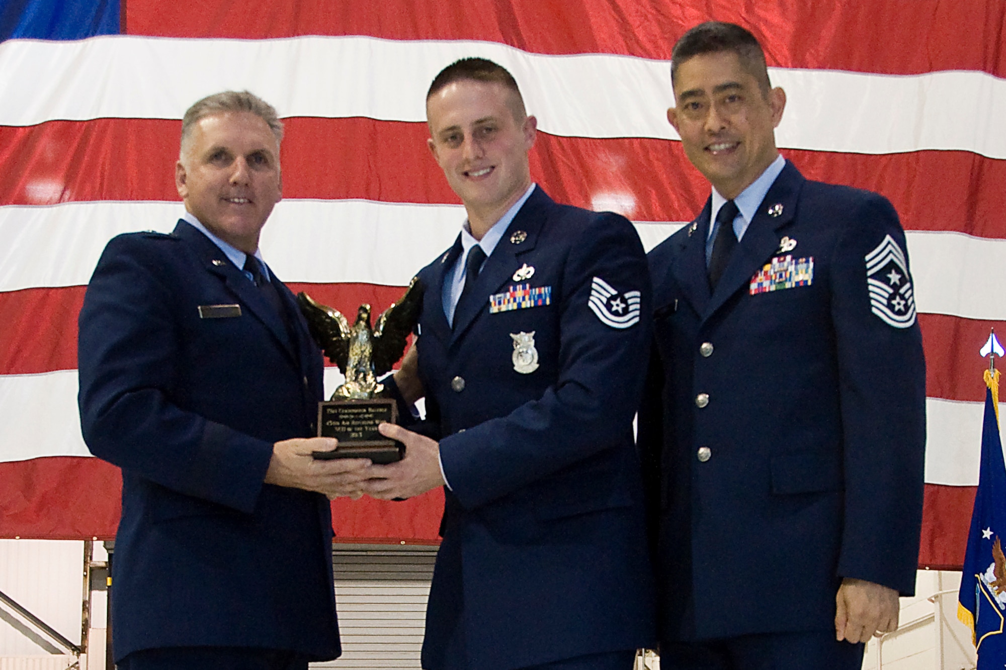 Brig. Gen. John C. Flournoy Jr., 4th Air Force commander, left, and Chief Master Sgt. Brian Wong, 4th AF command chief, right, present Tech. Sgt. Christopher Bauchle, 434th CES fire protection journeyman, with a 434th Air Refueling Wing Noncommissioned Officer of the Year for 2013 award at an annual awards banquet held at Grissom Air Reserve Base, Ind., April 12, 2014. Each year, time is set aside to honor Grissom Airmen who embody the Air Force's core values to the fullest extent through their actions and commitment to duty. (U.S. Air Force photo/Staff Sgt. Andrew McLaughlin)
