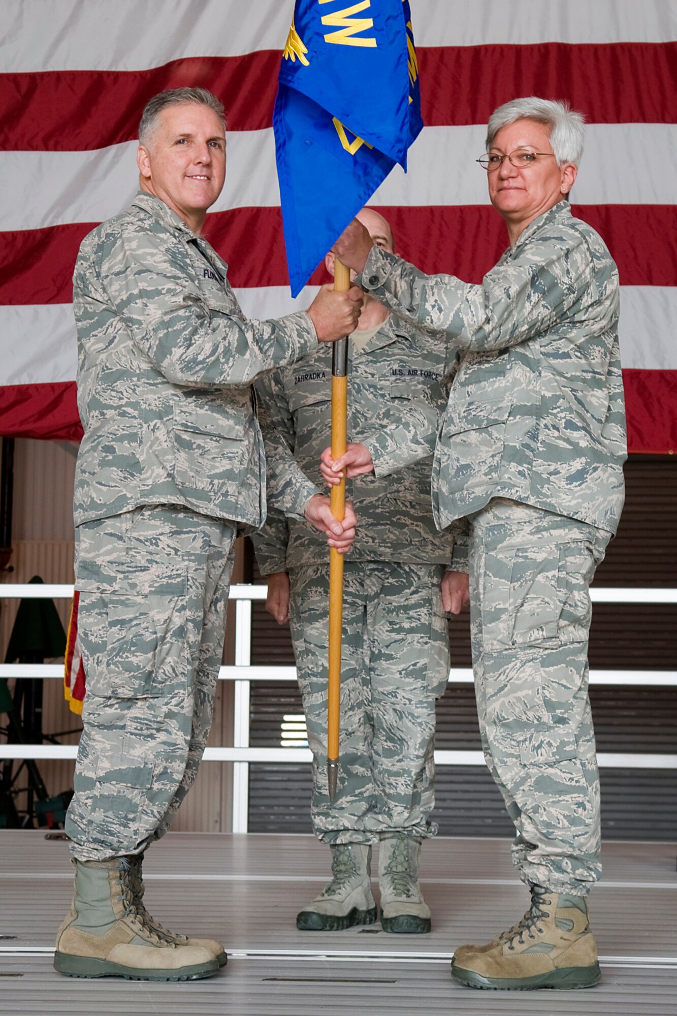 Brig. Gen. John C. Flournoy Jr., 4th Air Force commander, presents Col. Anna Schulte with the 434th Maintenance Group guidon as she takes command of the unit at Grissom Air Reserve Base, Ind., April 12, 2014. Prior to her new assignment, Schulte served as the 403rd Wing Maintenance Group commander at Keesler AFB, Miss. (U.S. Air Force photo/Staff Sgt. Andrew McLaughlin) 
