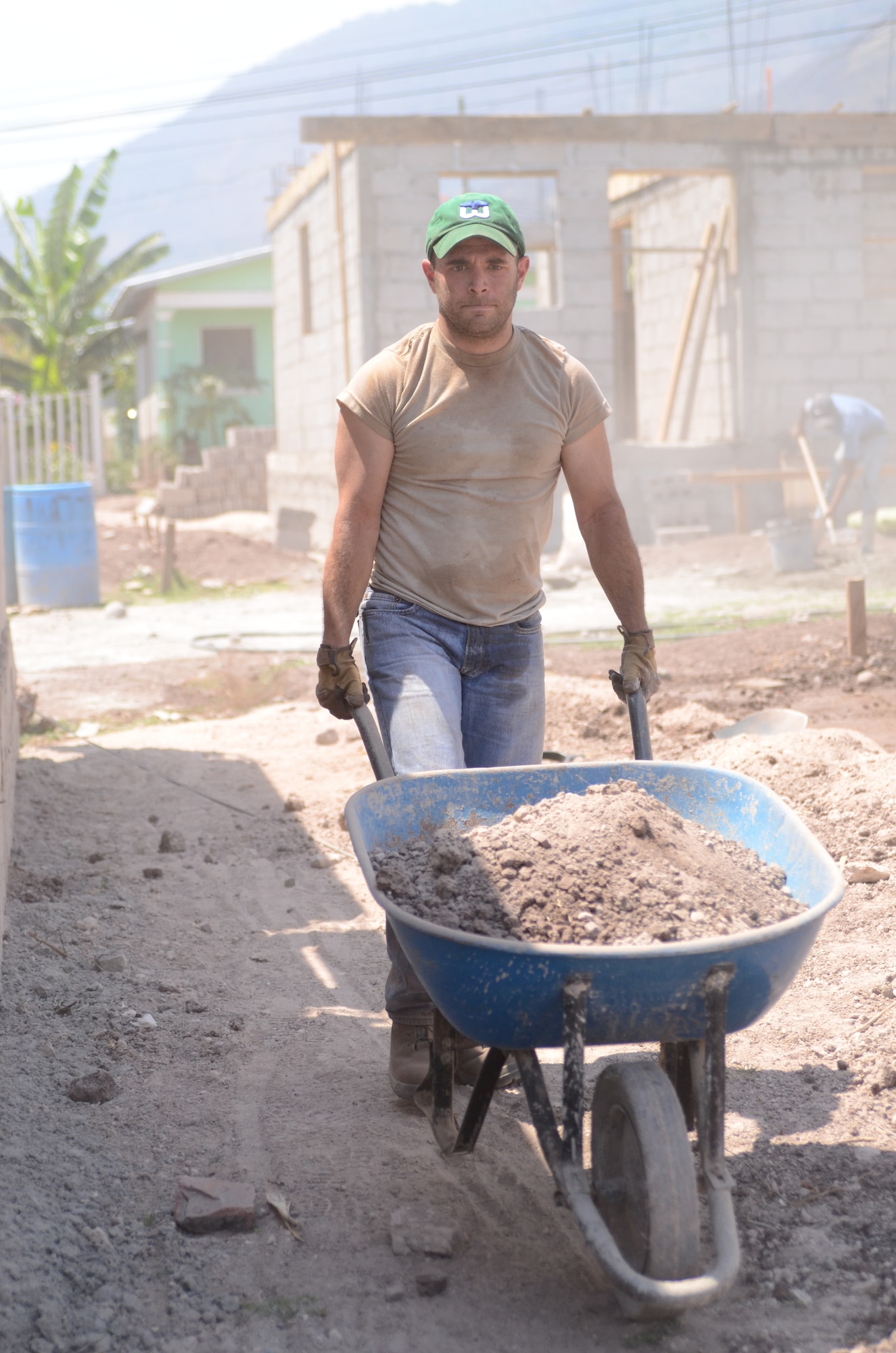 Twenty-one Joint Task Force-Bravo service members filled trenches, leveled ground and shoveled dirt at the Ajuterique Housing Project helping several Honduran families get closer to moving into their new homes April 5, 2014.  In conjunction with the Honduras Habit for Humanity, Siguatepeque region, the Municipality of Ajuterique and the Civil-Military Operations office at JTF-Bravo, these service members volunteered their labor to assist in the building of homes in the Ajuterique community.  The two-phased project includes building 38 two-bedroom, one-bath homes for low-income Hondurans who can afford to construct a home but doesn't own the land to build on. (Photo by U. S. Air Force Technical Sgt. Breihan Fetz)