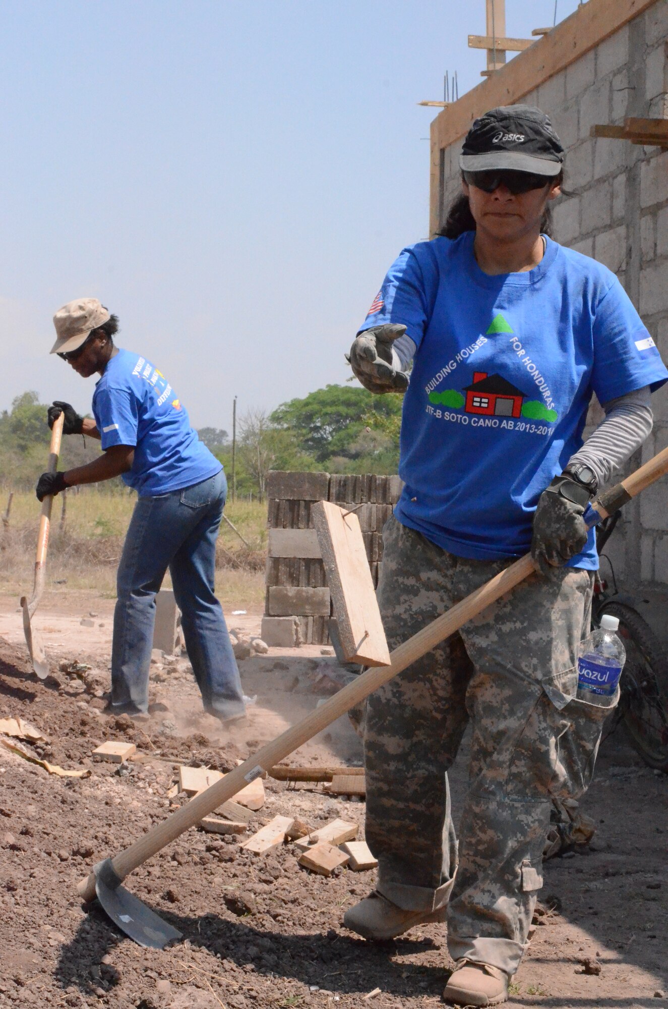 Twenty-one Joint Task Force-Bravo service members filled trenches, leveled ground and shoveled dirt at the Ajuterique Housing Project helping several Honduran families get closer to moving into their new homes April 5, 2014.  In conjunction with the Honduras Habit for Humanity, Siguatepeque region, the Municipality of Ajuterique and the Civil-Military Operations office at JTF-Bravo, these service members volunteered their labor to assist in the building of homes in the Ajuterique community.  The two-phased project includes building 38 two-bedroom, one-bath homes for low-income Hondurans who can afford to construct a home but doesn't own the land to build on. (Photo by U. S. Air Force Technical Sgt. Breihan Fetz)