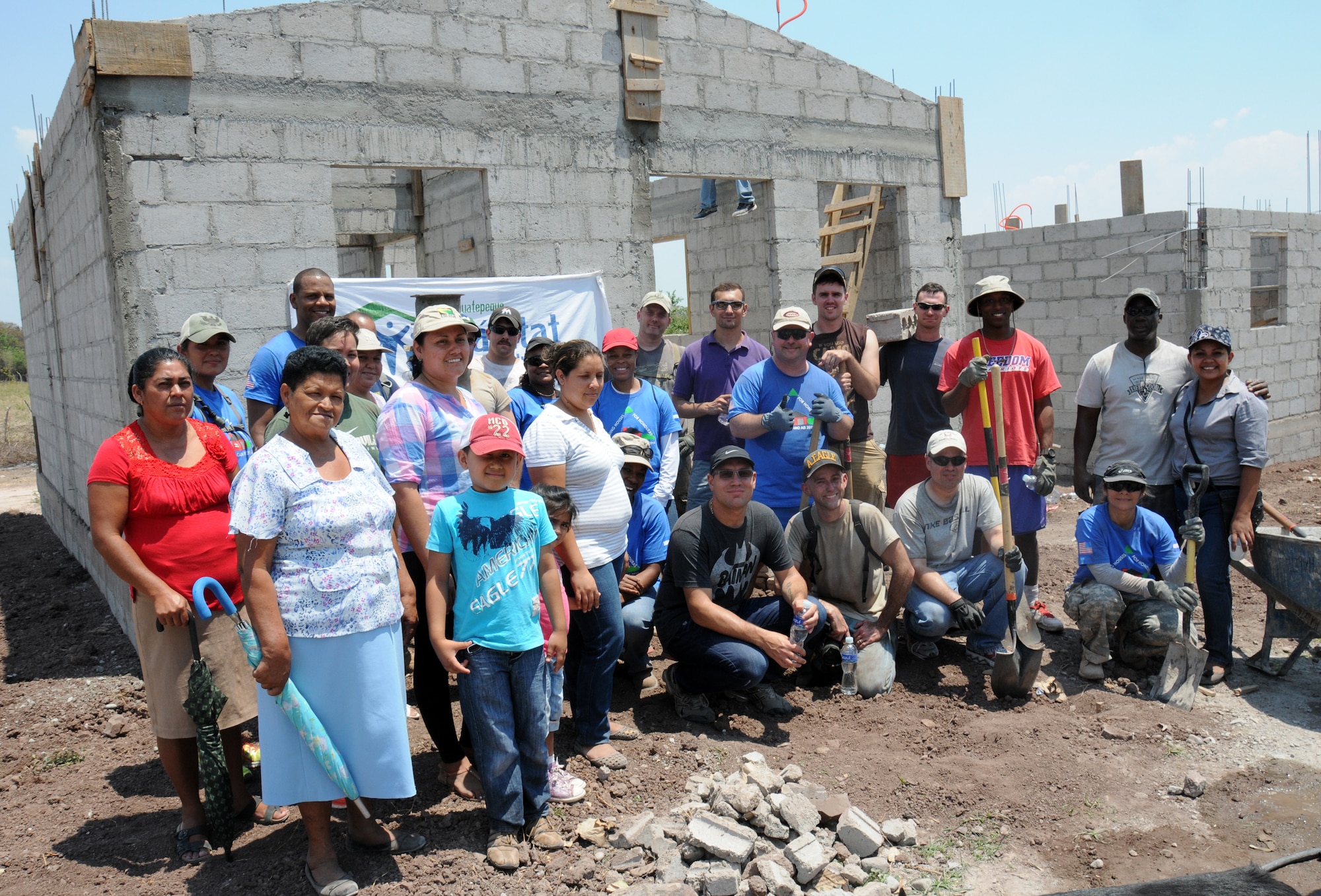 Twenty-one Joint Task Force-Bravo service members filled trenches, leveled ground and shoveled dirt at the Ajuterique Housing Project helping several Honduran families get closer to moving into their new homes April 5, 2014.  In conjunction with the Honduras Habit for Humanity, Siguatepeque region, the Municipality of Ajuterique and the Civil-Military Operations office at JTF-Bravo, these service members volunteered their labor to assist in the building of homes in the Ajuterique community.  The two-phased project includes building 38 two-bedroom, one-bath homes for low-income Hondurans who can afford to construct a home but doesn't own the land to build on. (Photo by U. S. Air National Guard Capt. Steven Stubbs)