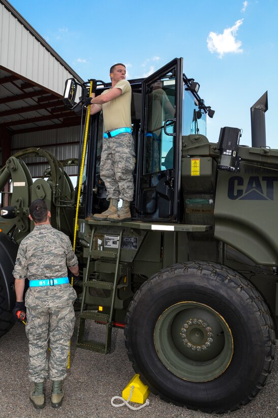 Airmen from the 81st Aerial Port Squadron at Joint Base Charleston, S.C. measure the height of a forklift during the first annual Port Dawg Challenge April 12, 2014. The event brought together the 38th and 81st Aerial Port Squadrons, both from the 315th Airlift Wing at Joint Base Charleston, who joined forces to compete in the challenge and showcase their aerial port skills. The day of events included pallet loading, load planning, a forklift obstacle course, simulated passenger processing and a joint inspection of a vehicle. (U.S. Air Force photo/Tech. Sgt. Shane Ellis) 