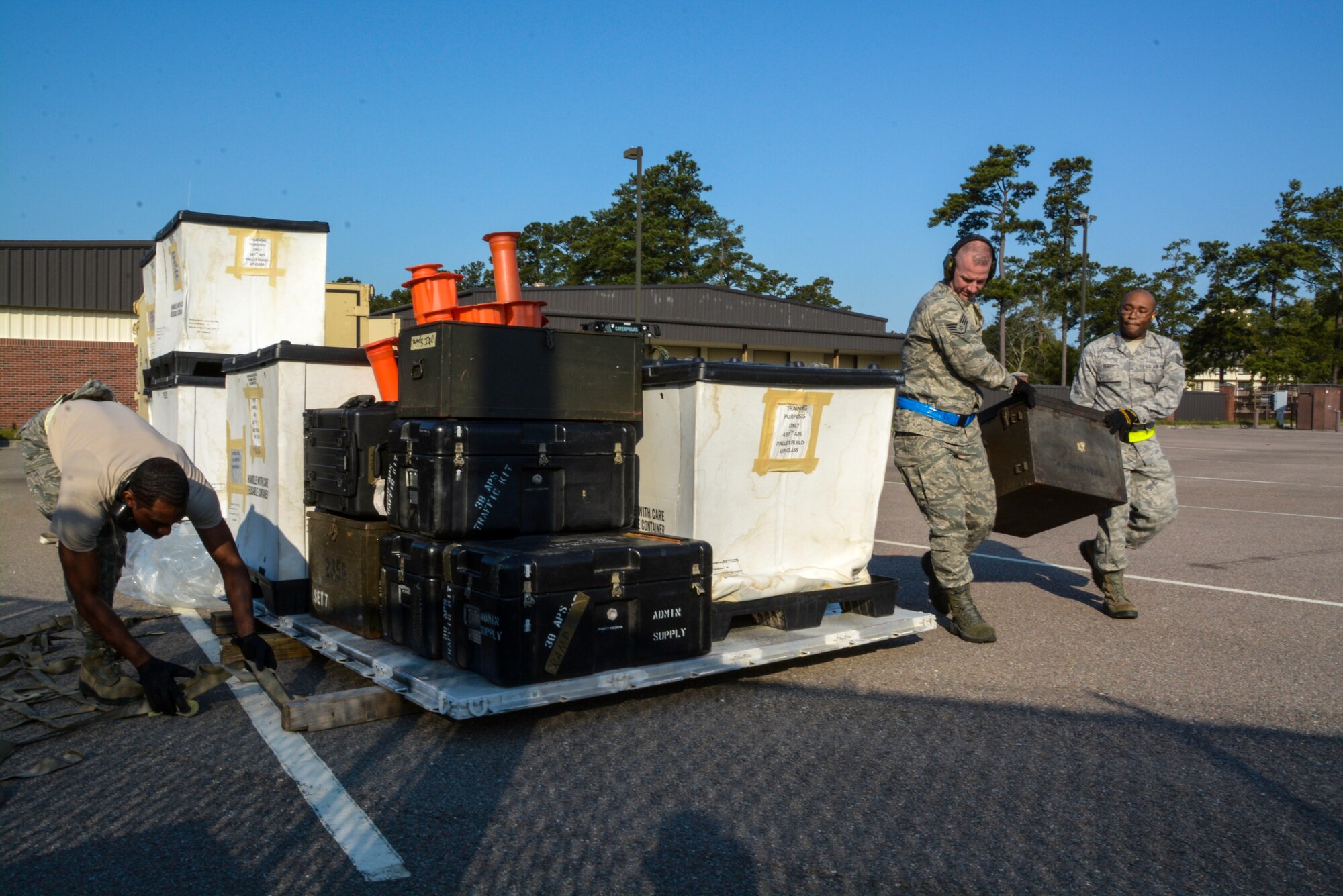 Airmen from the 38th Aerial Port Squadron at Joint Base Charleston, S.C. build a pallet during the first annual Port Dawg Challenge April 12, 2014. The event brought together the 38th and 81st Aerial Port Squadrons, both from the 315th Airlift Wing at Joint Base Charleston, who joined forces to compete in the challenge and showcase their aerial port skills. The day of events included pallet loading, load planning, a forklift obstacle course, simulated passenger processing and a joint inspection of a vehicle. (U.S. Air Force photo/Tech. Sgt. Shane Ellis) 