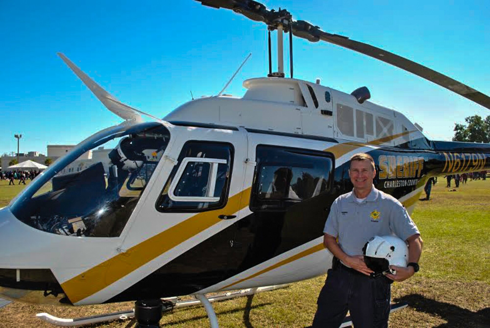 Master Sgt. Jerry Henning pauses for a photo by a helicopter that he flies in as an air observer with the Charleston County Sheriff’s Office. Henning is a security forces manager with the 315th Airlift Wing at Joint Base Charleston, and he serves as a volunteer for the Charleston County Sheriff’s Office. (Courtesy photo)
