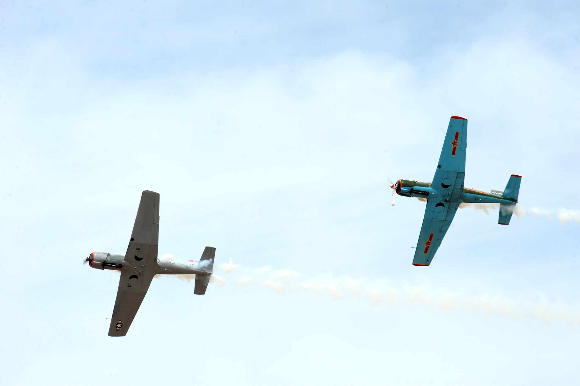 Two Desert Rats Warbirds fly during the Thunder and Lightning over Arizona event at Davis-Monthan Air Force Base, Ariz., April 12, 2014. The Desert Rats performed aerial stunts above a crowd of more than 100,000 people that attended the event. (U.S. Air Force photo by Airman 1st Class Chris Massey/Released)
