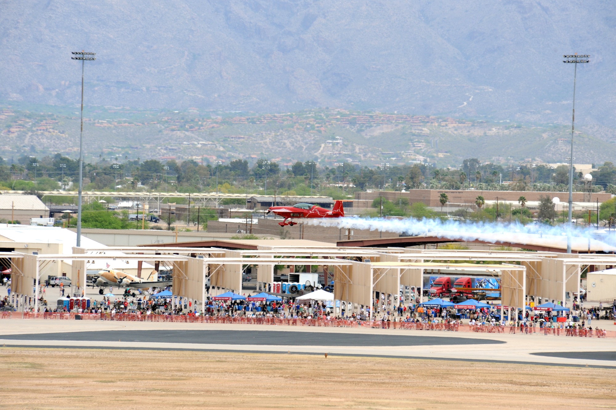 Attendees watch the Jacquie B aerial demonstration during the Thunder and Lightning over Arizona event at Davis-Monthan Air Force Base, Ariz., April 12, 2014.  D-M held the event to show appreciation by opening its gates and allowing the general public to learn more about the U.S. Air Force while viewing aerial demonstrations.  (U.S. Air Force Photo by Airman 1st Class Chris Massey/Released)