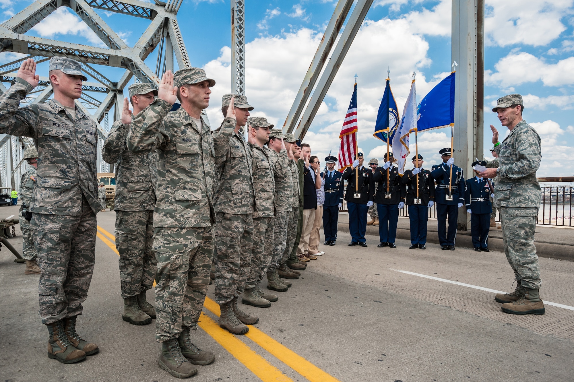 Lt. Gen. Stanley E. Clarke III, director of the Air National Guard, administers the oath of enlistment to 15 members of the Kentucky Air National Guard on the 2nd Street Bridge in Louisville, Ky., April 12, 2014. The event kicked off Thunder Over Louisville, the city’s annual air show and fireworks display over the Ohio River. (U.S. Air National Guard photo by Maj. Dale Greer)