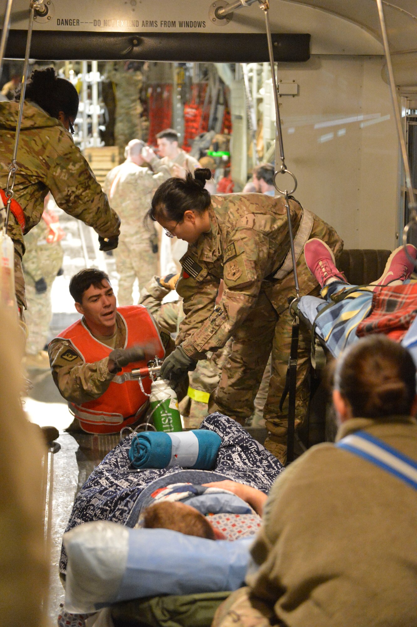 A patient is loaded into the back of a bus at Bagram Airfield, Afghanistan, after being transported via C-130J Super Hercules by the 455th Expeditionary Aeromedical Evacuation Squadron from another location in Afghanistan, April 3, 2014. The patient was being moved to a higher level of care at the Craig Joint Theater Hospital in Bagram.(U.S. Air Force photo by Senior Master Sgt. Gary J. Rihn/Released)