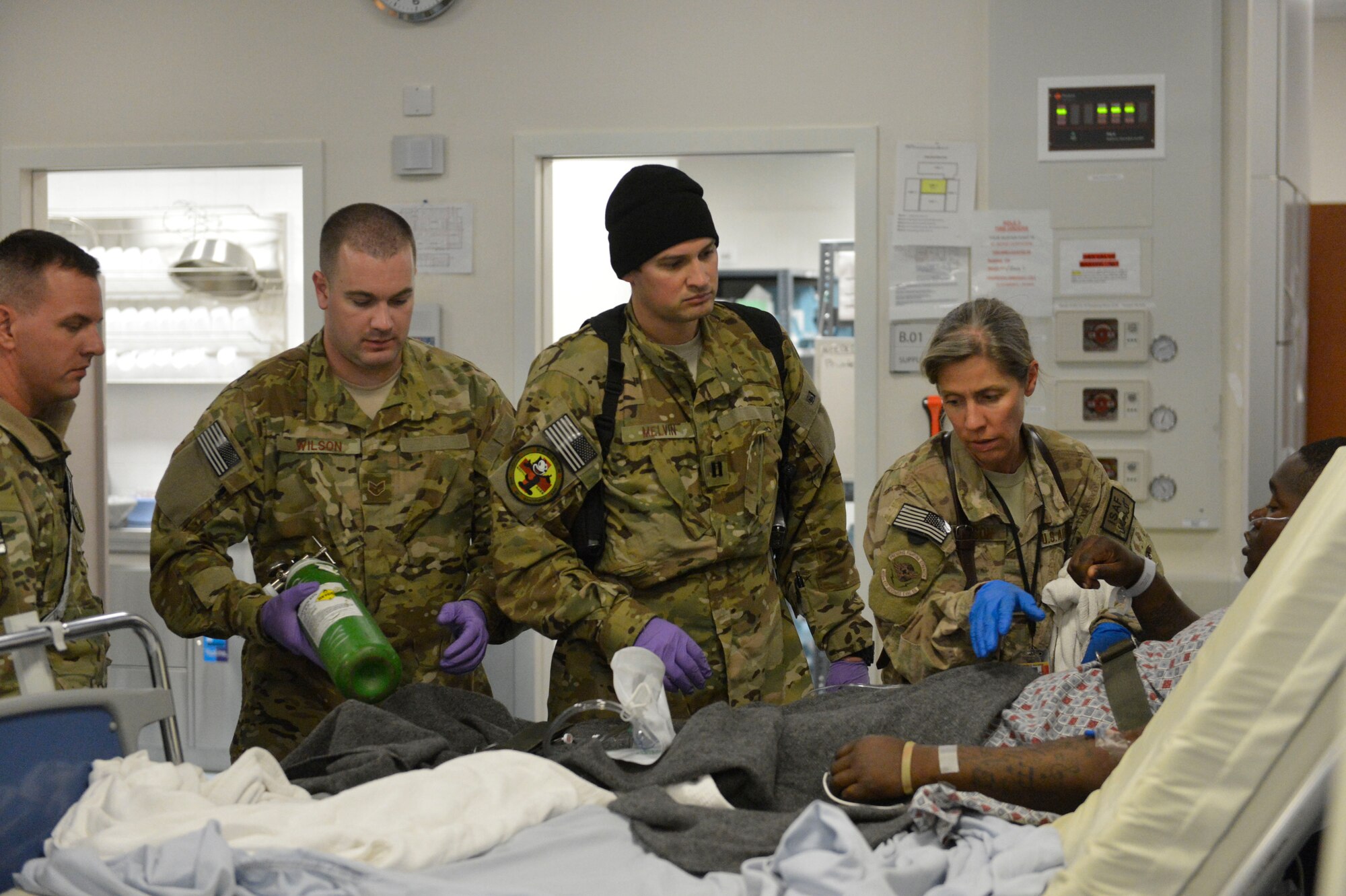 U.S. Air Force Staff Sgt. Robert Wilson, a respiratory therapist, and Capt. Jason Melvin, critical care nurse, of the 455th Expeditionary Aeromedical Evacuation Squadron, Bagram Airfield, Afghanistan, along with Maj. Deborah Davidson, director of operations for the Kandahar Patient Movement Element, prepare a patient at the Kandahar Airfield hospital for C-130J Super Hercules transport, April 3, 2014. The patient was being transferred to a higher level of care.(U.S. Air Force photo by Senior Master Sgt. Gary J. Rihn/Released)
