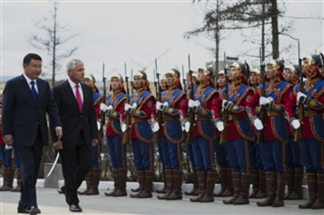 U.S. Defense Secretary Chuck Hagel, right, walks in a pass-and-review ceremony with Mongolian Defense Minister Dashdemberal Bat-Erdene during an honor cordon at the Mongolian Ministry of Defense in Ulaanbaatar, Mongolia, April 10, 2014. Hagel met with his counterparts to discuss issues of mutual importance.