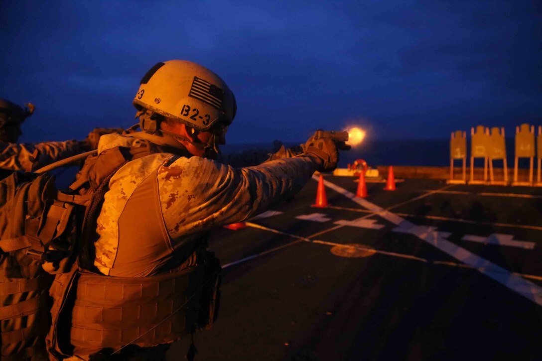 Sgt. Luis Martinez, a reconnaissanceman with the Maritime Raid Force, 11th Marine Expeditionary Unit, sights in on his designated target with an M1911 .45 caliber pistol during Special Operations Training Group (SOTG) close quarters tactics qualification aboard the USS San Diego, as part of Amphibious Squadron Marine Expeditionary Unit Integration Training (PMINT) off the coast of San Diego, April 13, 2014. PMINT is the first at-sea event in the 11th MEU’s predeployment training program where the unit will conduct training operations alongside the Makin Island Amphibious Ready Group.. (U.S. Marine Corps photo by Cpl. Demetrius Morgan/RELEASED)