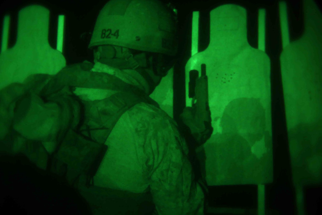 A Marine with the Maritime Raid Force, 11th Marine Expeditionary Unit, performs a speed reload of his M1911 .45 caliber pistol during a Special Operations Training Group (SOTG) close quarters tactics qualification course on the flight deck of the USS San Diego as part of Amphibious Squadron Marine Expeditionary Unit Integration Training (PMINT) off the coast of San Diego, April 13, 2014. PMINT is conducted by the 11th MEU and the Makin Island Amphibious Ready Group and is the first opportunity for the MEU/ARG team to exercise its planning processes and execute operations at sea. (U.S. Marine Corps photo by Cpl. Jonathan R. Waldman/RELEASED)