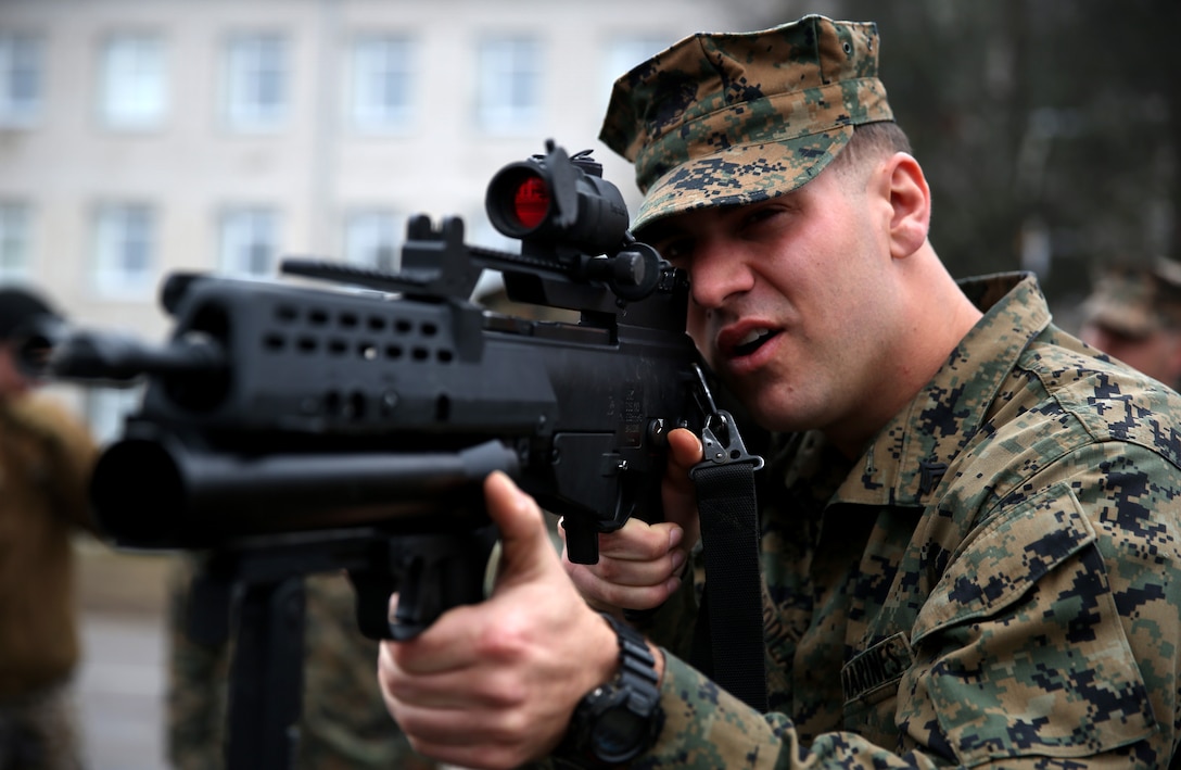 Corporal Marcus Thibodeau, an anti-tank missileman with Weapons Company, 3rd Battalion, 8th Marine Regiment, 2nd Marine Division assigned to Black Sea Rotational Force 14, examines a Latvian G36 rifle during Summer Shield aboard Camp Adazi, Latvia, April 7, 2014. This is the 11th iteration of the Summer Shield exercise, a joint staff planning and combined arms live fire maneuver event designed to enhance the Latvian Land Force’s capacity and capability to integrate fires and maneuver at the battalion and brigade level as well as increase partner capacity, promote regional stability, and continue to develop Latvian, Lithuanian, Estonian and U.S. interoperability. (Official Marine Corps photo by Lance Cpl. Scott W. Whiting, BSRF PAO/ Released)