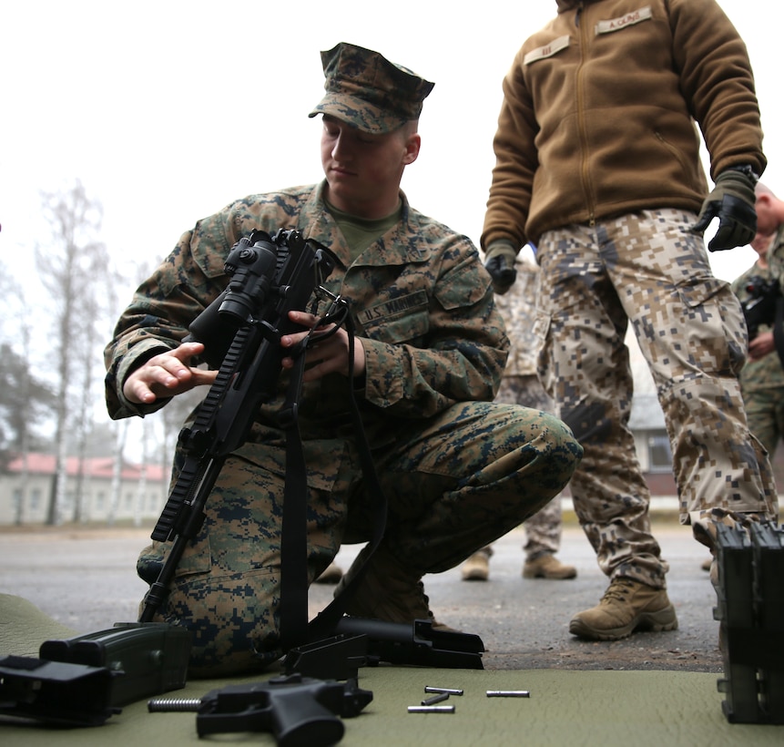 Private First Class Joseph Mailloux, an infantryman with 3rd Battalion, 8th Marine Regiment, 2nd Marine Division assigned to Black Sea Rotational Force 14, learns how to disassemble a Latvian G36 rifle during Summer Shield aboard Camp Adazi, Latvia, April 7, 2014. This is the 11th iteration of the Summer Shield exercise, a joint staff planning and combined arms live fire maneuver event designed to enhance the Latvian Land Force’s capacity and capability to integrate fires and maneuver at the battalion and brigade level as well as increase partner capacity, promote regional stability, and continue to develop Latvian, Lithuanian, Estonian and U.S. interoperability. (Official Marine Corps photo by Lance Cpl. Scott W. Whiting, BSRF PAO/ Released)