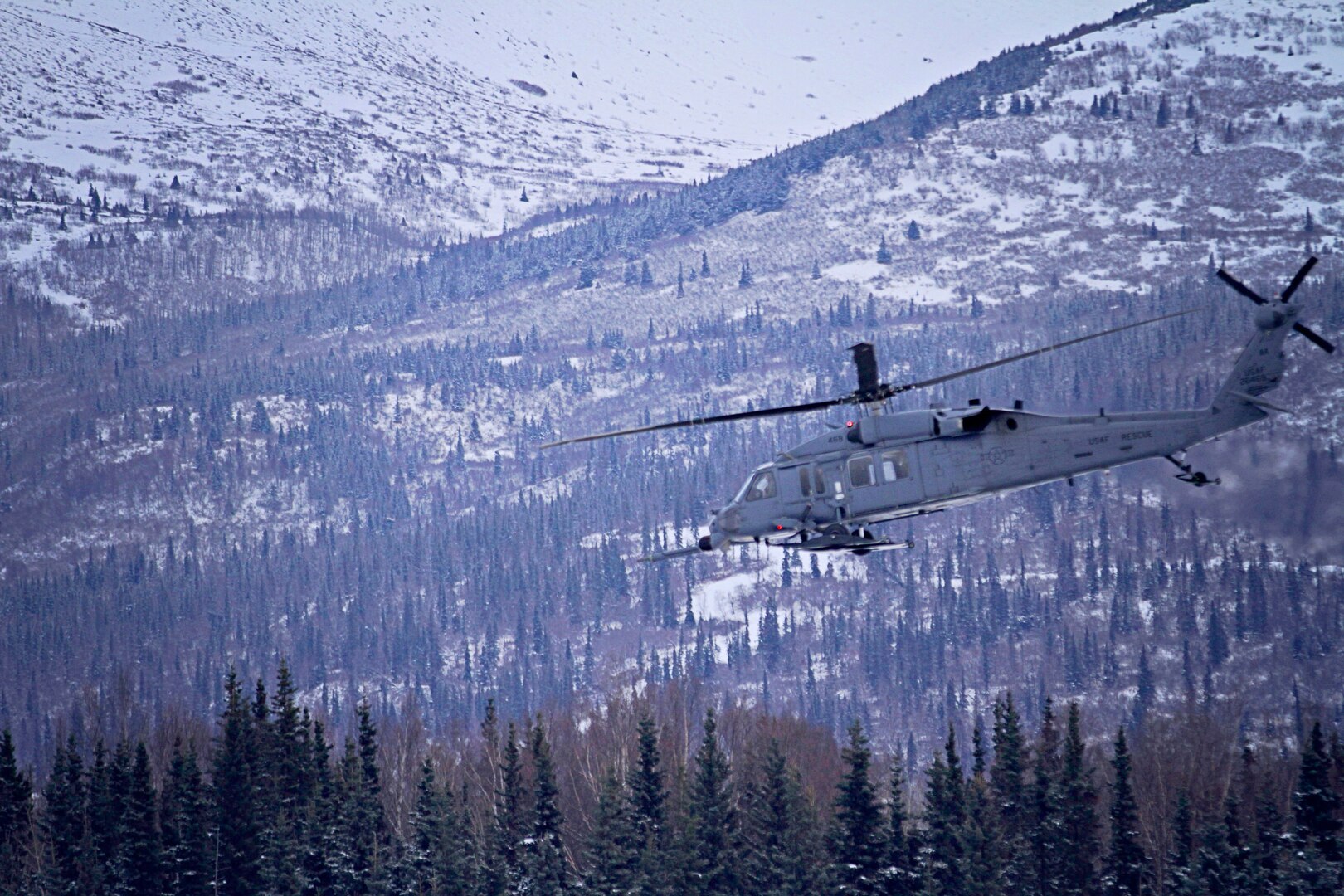 A flight crew with the Alaska Air National Guard's 210th Rescue Squadron conducts training with an HH-60 Pave Hawk helicopter near Bryant Airfield on Joint Base Elmendorf-Richardson Jan. 29, 2013. The mission of the 210th Rescue Squadron is to train for combat search and rescue and be on 24-hour alert to respond to search and rescue for the state of Alaska. 