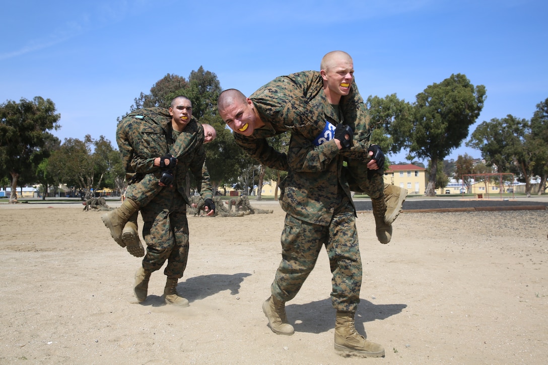 Recruits fireman carry on another to simulate evacuating a casualty. The Combat Conditioning Exercise consists of 20 stations of Marine Corps Martial Arts Program remediation and physical fitness exercises.