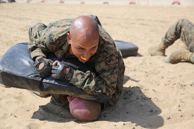 Company K recruits execute elbow strikes aboard the depot, March 29. Recruits remediate the Marine Corps Martial Arts Program techniques that they will be tested on later in recruit training.
