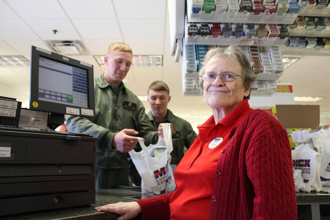 Diane Frazier, cashier at Marine Mart on Barnett Avenue, aboard Marine Corps Base Quantico, smiles as she completes a transaction with two Marines from Marine Helicopter Squadron One at the Marine Mart on March 26, 2014. Frazier will retire  June 27, 2014, from Marine Corp Community Services, after 23 years of service. 
