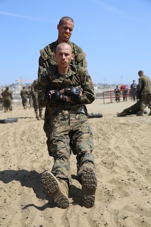 Recruit Cody A. Stout, Platoon 3235, gets buddy dragged by another recruit to transition from one station to the next during the Combat Conditioning Exercise aboard the depot, March 29. Recruits only go through the CCX once in recruit training.