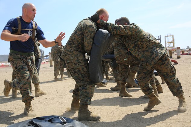Recruits of Company K, 3rd Recruit Training Battalion, remediate the knee striking technique aboard the depot, March 29. The Combat Conditioning Exercise was designed to wear recruit out but to not let them quit. 