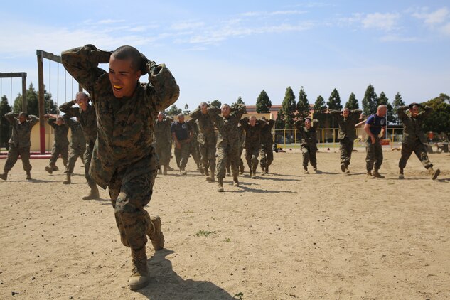 Company K recruits transition to the next station by performing lunges aboard the depot, March 29. Recruits were given 90 seconds at each station before they moved to the next exercise.