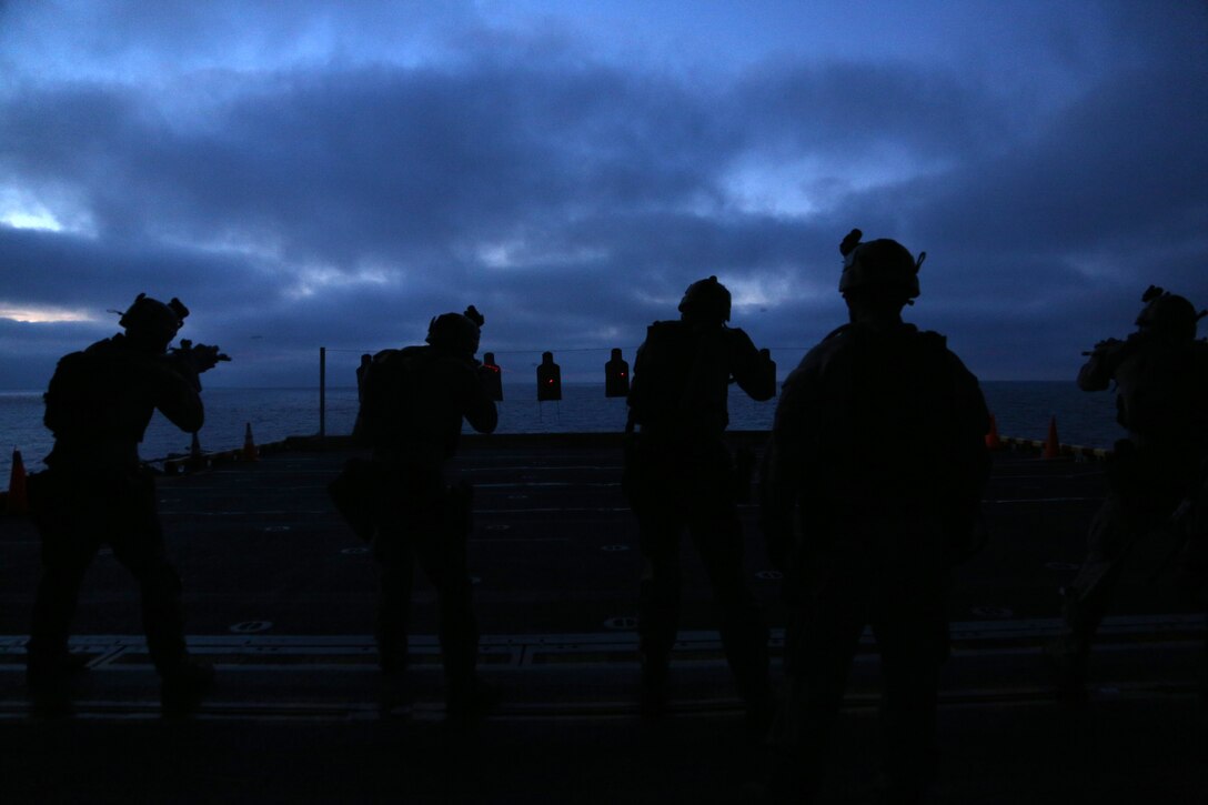 Marines with the Maritime Raid Force, 11th Marine Expeditionary Unit, conduct combat drills on the air cargo elevator of the USS Makin Island during Amphibious Squadron Marine Expeditionary Unit Integration Training (PMINT), off the coast of San Diego, Calif., April 10, 2014. PMINT is a two-week long pre-deployment training event focusing on the combined capabilities of the Marine Expeditionary Unit and Amphibious Ready Group (ARG), conducting amphibious operations, crisis response and limited contingency operations. (U.S. Marine Corps photo by Gunnery Sgt. Rome M. Lazarus/Released)
