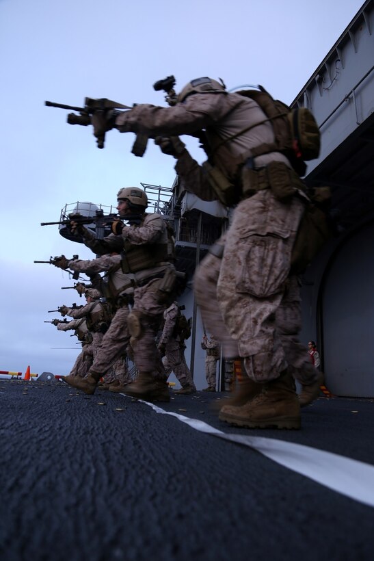 Marines with the Maritime Raid Force, 11th Marine Expeditionary Unit, conduct combat drills on the air cargo elevator of the USS Makin Island during Amphibious Squadron Marine Expeditionary Unit Integration Training (PMINT), off the coast of San Diego, Calif., April 10, 2014. PMINT is a two-week long pre-deployment training event focusing on the combined capabilities of the Marine Expeditionary Unit and Amphibious Ready Group (ARG), conducting amphibious operations, crisis response and limited contingency operations. (U.S. Marine Corps photo by Gunnery Sgt. Rome M. Lazarus/Released)
