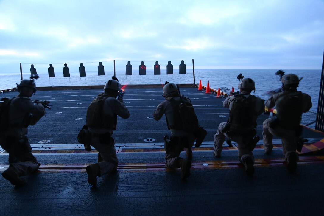 Marines with the Maritime Raid Force, 11th Marine Expeditionary Unit, conduct a table two and three course of fire on an air cargo elevator aboard the USS Makin Island during Amphibious Squadron Marine Expeditionary Unit Integration Training (PMINT) off the coast of San Diego, Calif., April 10, 2014.  PMINT is a two-week predeployment training event focused on the combined capabilities of the MEU and Amphibious Ready Group (ARG), conducting amphibious operations, crisis response and limited contingency operations.  (U.S. Marine Corps photo by Lance Cpl. Laura Y. Raga/Released)