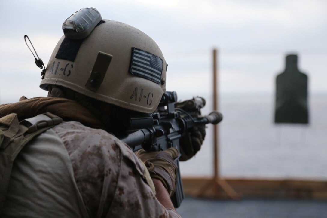 A Marine with the Maritime Raid Force, 11th Marine Expeditionary Unit, engages a target during a table two and three course of fire on an air cargo elevator aboard the USS Makin Island as part of Amphibious Squadron Marine Expeditionary Unit Integration Training (PMINT) off the coast of San Diego, Calif., April 10, 2014.  PMINT is a two-week predeployment training event focused on the combined capabilities of the MEU and Amphibious Ready Group (ARG), conducting amphibious operations, crisis response and limited contingency operations.  (U.S. Marine Corps photo by Lance Cpl. Laura Y. Raga/Released)