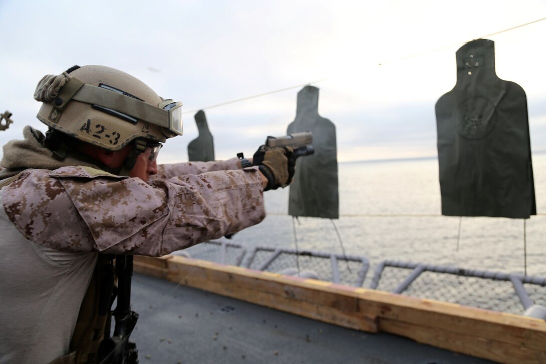 A Marine with the Maritime Raid Force, 11th Marine Expeditionary Unit, engages a target during a table two and three course of fire on an air cargo elevator aboard the USS Makin Island as part of Amphibious Squadron Marine Expeditionary Unit Integration Training (PMINT) off the coast of San Diego, Calif., April 10, 2014.  PMINT is a two-week predeployment training event focused on the combined capabilities of the MEU and Amphibious Ready Group (ARG), conducting amphibious operations, crisis response and limited contingency operations.  (U.S. Marine Corps photo by Lance Cpl. Laura Y. Raga/Released)