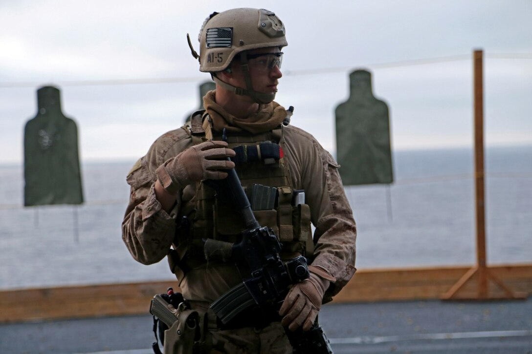 Sgt. Michael Currier, a Marine with the Maritime Raid Force, 11th Marine Expeditionary Unit, awaits instruction prior to a table two and three course of fire on an air cargo elevator aboard the USS Makin Island during Amphibious Squadron Marine Expeditionary Unit Integration Training off the coast of San Diego, Calif., April 10, 2014.  PMINT is a two-week predeployment training event focused on the combined capabilities of the MEU and Amphibious Ready Group, conducting amphibious operations, crisis response and limited contingency operations.  (U.S. Marine Corps photo by Lance Cpl. Laura Y. Raga/Released)