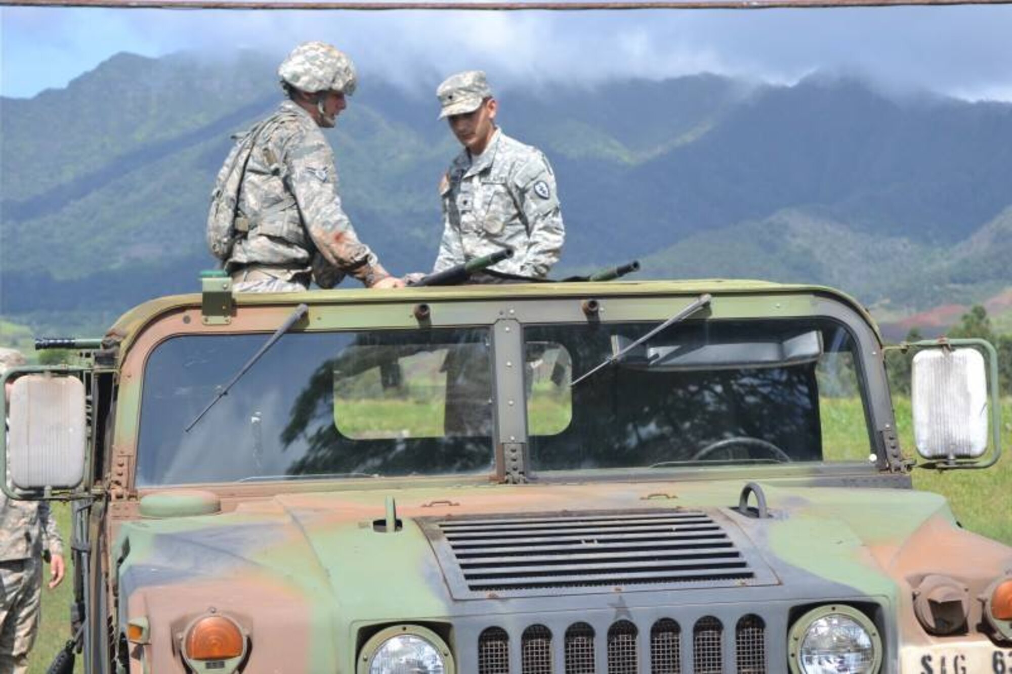 An Airman and a Soldier Expert Field Medical Badge course candidates load a litter onto the back of a HUMVEE during the EFMB course at Schofield Army Barracks, Hawaii, March 31 through April 11, 2014. The candidates had to demonstrate their ability to load a casualty onto a standard and non-standard platform. Additionally, to successfully complete the course, students had to demonstrate their proficiency at tactical combat casualty care, take a written test, execute U.S. Army Warrior communications and chemical, biological, radiological, nuclear and high-yield explosives tasks, perform day and night land navigation and complete a 12-mile road march. (U.S. Army photo courtesy of 25th Infantry Division)