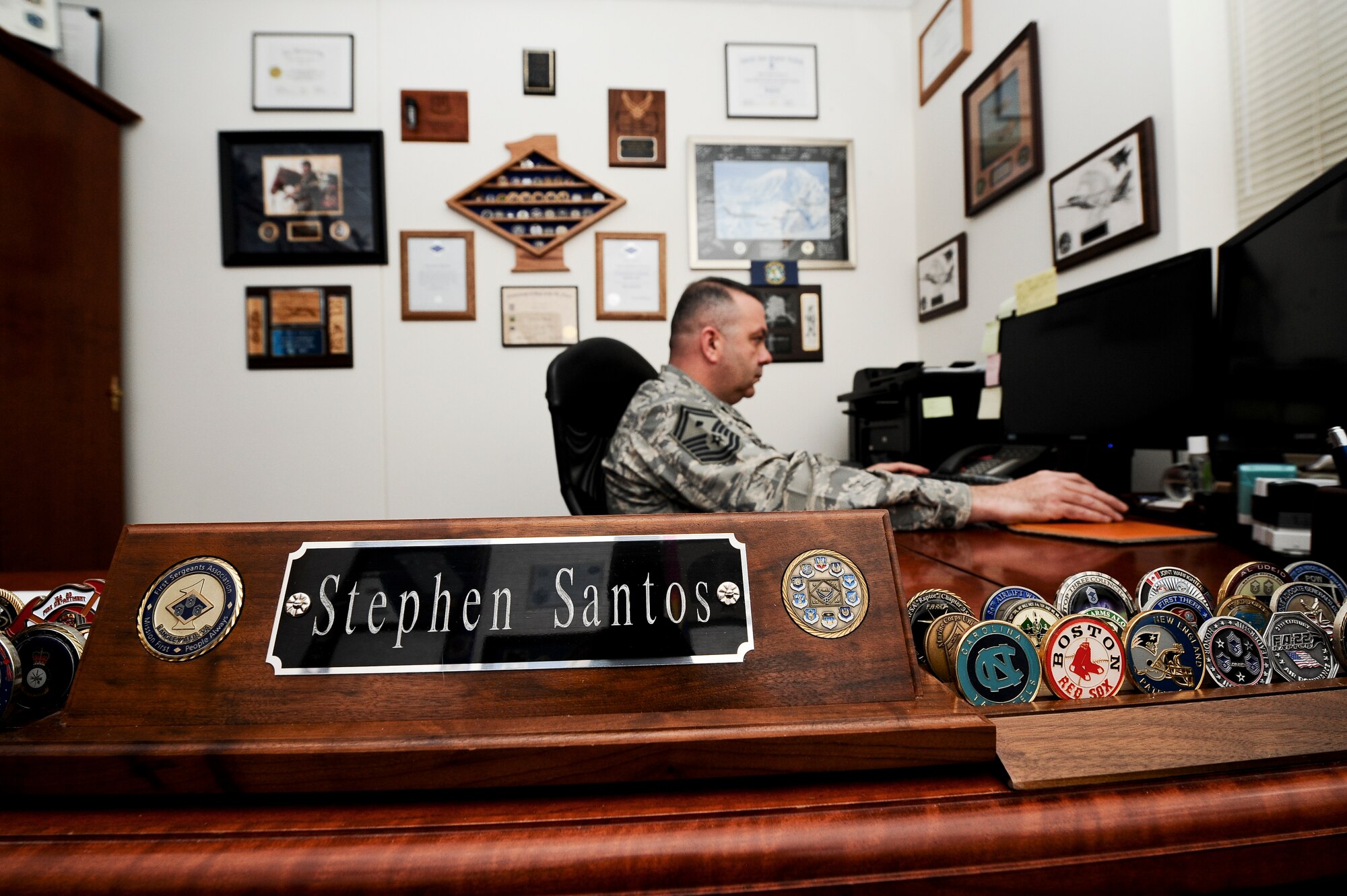 Senior Master Sgt. Stephen Santos, 566th Intel Squadron first sergeant, works in his office April 2, 2014, at the “” building on Buckley Air Force Base, Colo. Santos was selected for chief master sergeant, in the supplemental list, becoming one of 25 chief first sergeants in the Air Force. (U.S. Air Force photo by Senior Airman Phillip Houk/Released)