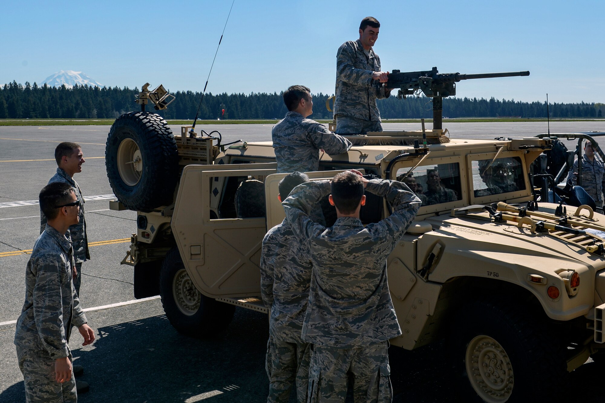 Cadet Dylan Flynn, U.S. Air Force Academy student, pulls the retracting slide handle on a .50 caliber machine gun, mounted on a High Mobility Multipurpose Wheeled Vehicle at the 22nd Special Tactics Squadron during the U.S. Air Force Academy CS-35 cadet visit, April 11, 2014 at Joint Base Lewis-McChord, Wash. The cadets toured McChord Field from April 10 through April 13, 2014 visiting five different squadrons. (U.S. Air Force photo/Staff Sgt. Russ Jackson)