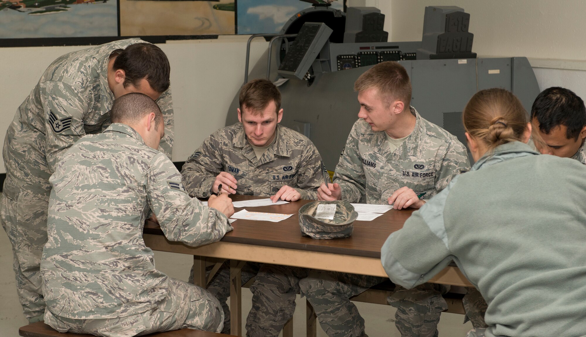 Airmen fill out paper work before going through a simulated base check-in April 14, 2014, Mountain Home Air Force Base, Idaho. Sharpshooter 14-02 is a base wide exercise that will last one week. (Air Force photo by Airman 1st Class Malissa Lott)