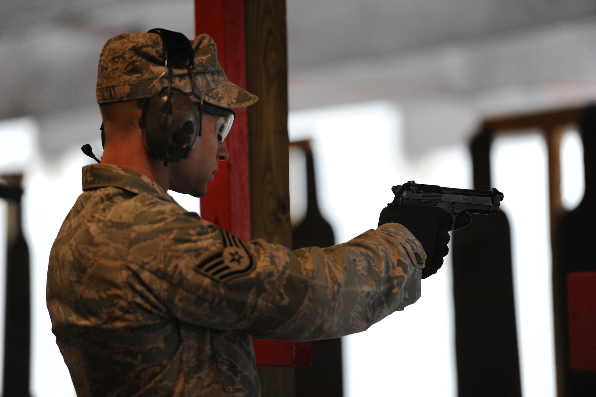 Staff Sgt. Justin Lambert, 375th Security Forces Squadron defender, shoots his weapon during a training session at Scott Air Force Base, Ill. on April 7, 2014. Sixteen bases and agencies came together for a week-long training aimed at highering training standards. (U.S. Air Force photo/Senior Airman Sarah Hall-Kirchner)
