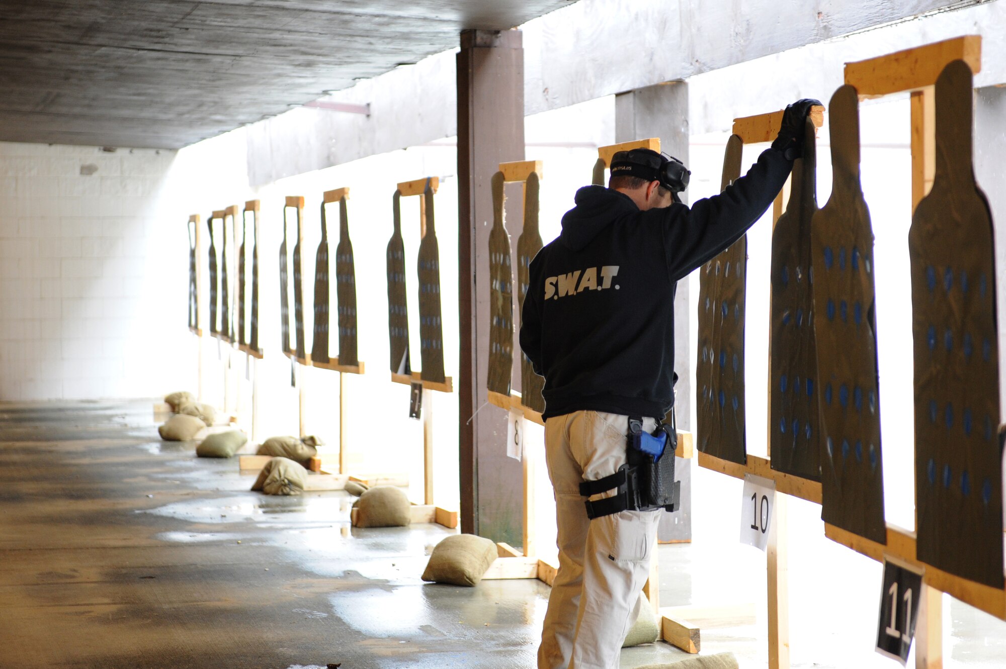 A team member moves targets to the right distance on the firing range at Scott Air Force Base, Ill. on April 7, 2014. Members from 16 bases and agencies came together for a week-long training aimed at achieving higher training standards for security forces members. (U.S. Air Force photo/Senior Airman Sarah Hall-Kirchner)