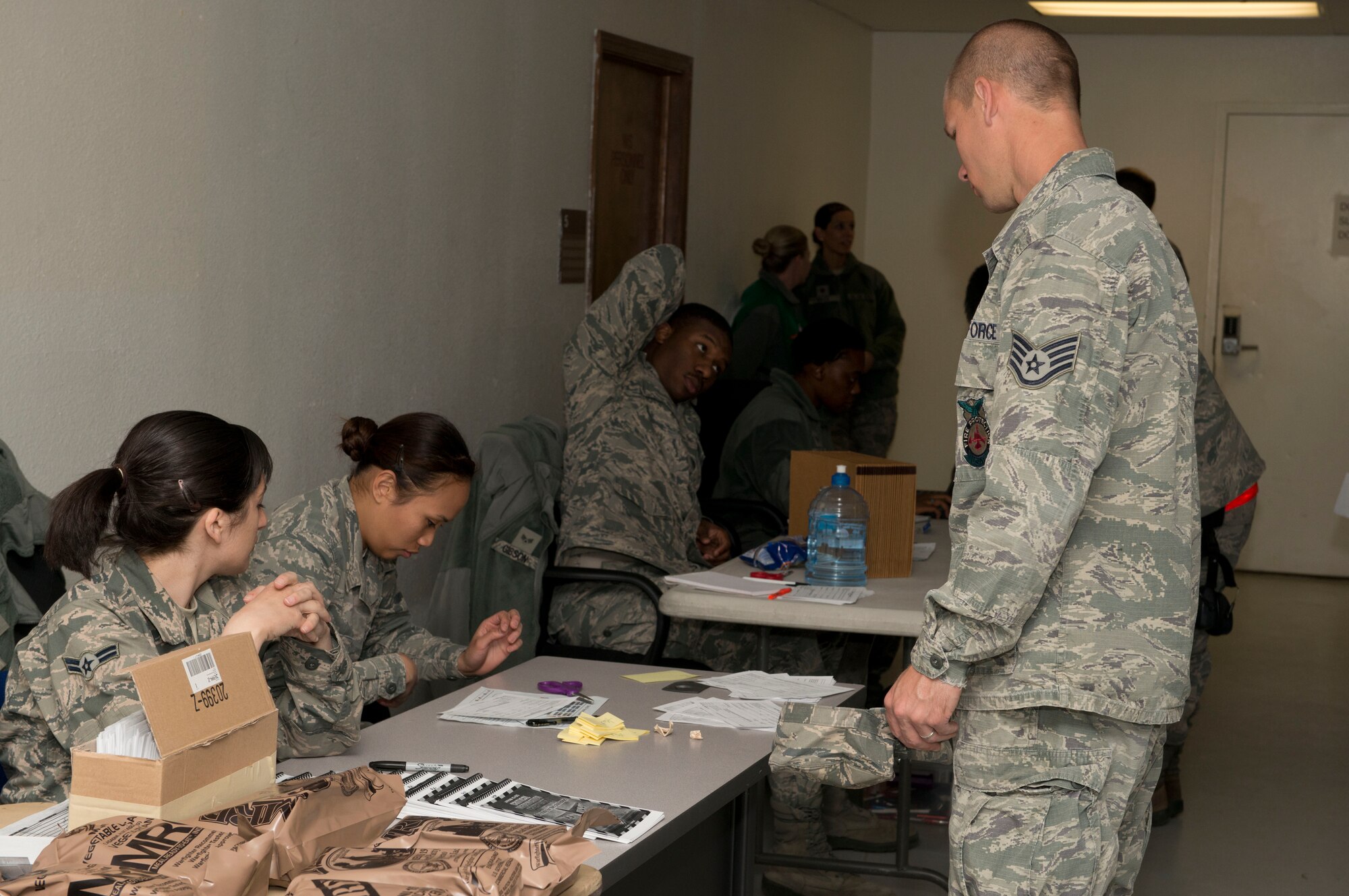 Airmen simulate arriving in-country during the Sharpshooter 14-02 exercise April 14, 2014, Mountain Home Air Force Base, Idaho. Airmen in-processing had the opportunity to receive prepackaged meals for the exercise. (Air Force photo by Airman 1st Class Malissa Lott)